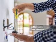 Electrician working on wall wiring