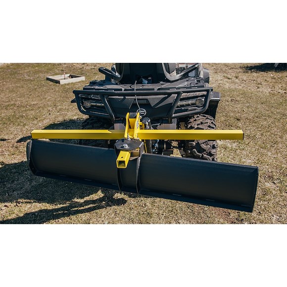 ATV fitted with a grading blade